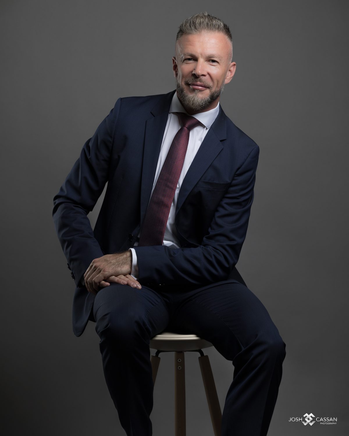 Ilya Kolmogorov, seated, in a navy suit